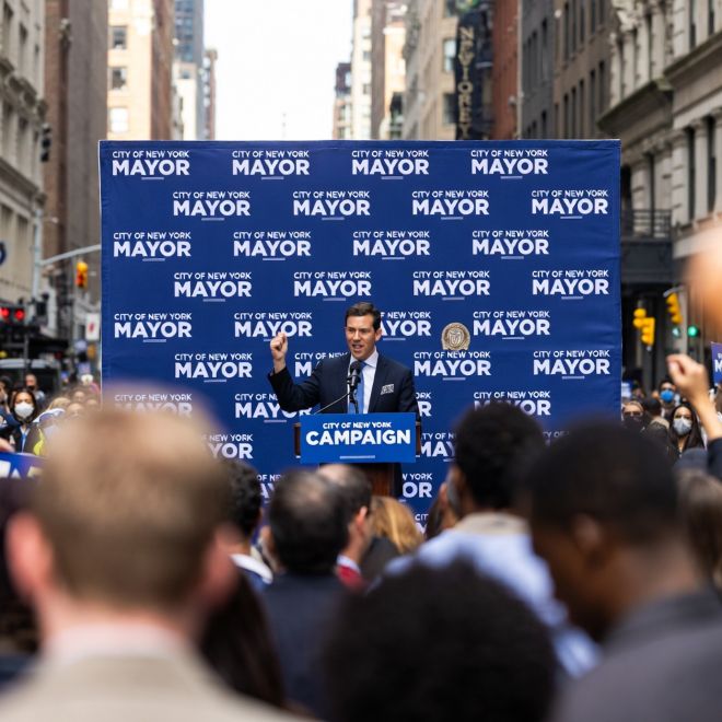 NYC campaign rally with a step-and-repeat banner